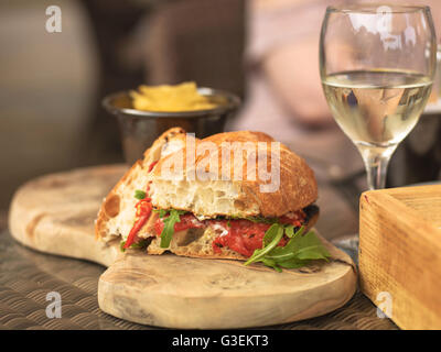Vegetarian Italian Style Red Pepper Ciabatta Bread Sandwich With Glass  White Wine On Wooden Serving Board Stock Photo
