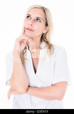 portrait of a blond woman in a white overall looking thoughtful Stock Photo