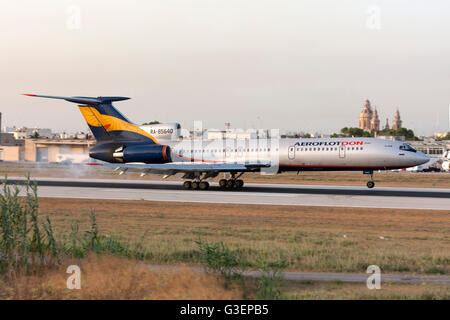 Aeroflot-Don Tupolev Tu-154M landing runway 14, just as the sun is about to set. Stock Photo