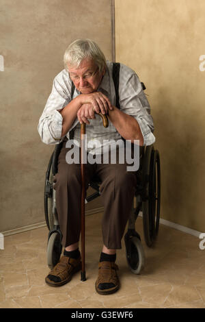 Lonely old man in nursing home leaning on his cane Stock Photo