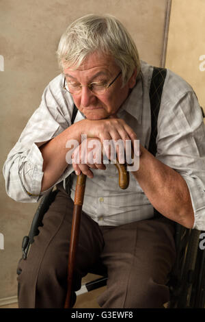 Lonely old man in nursing home leaning on his cane Stock Photo