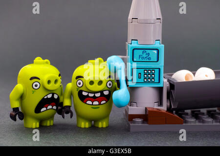 Tambov, Russian Federation - April 14, 2016 Lego Angry Birds. Two bad piggies with Pig Phone. Studio shot. Stock Photo