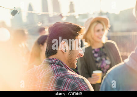 Young adult friends enjoying rooftop party Stock Photo
