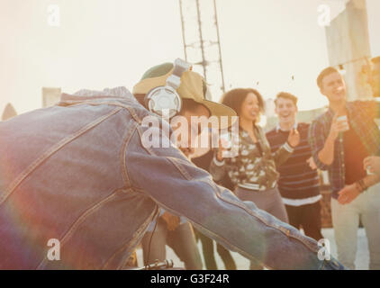 DJ with headphones at rooftop party Stock Photo