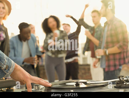 DJ spinning record at rooftop party Stock Photo