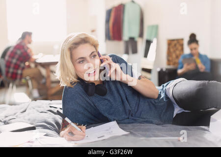 Female college student studying on bed Stock Photo