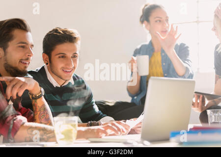 Creative young business people working at laptop Stock Photo