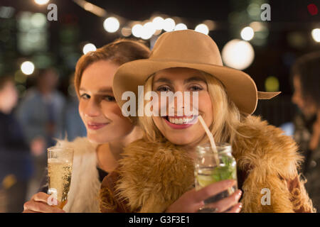 Portrait smiling young women drinking cocktails at party Stock Photo