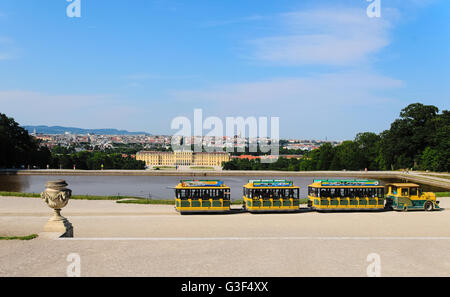 Panoramic view of the Schonbrunn Palace in Vienna with the touristic small train in the foreground Stock Photo