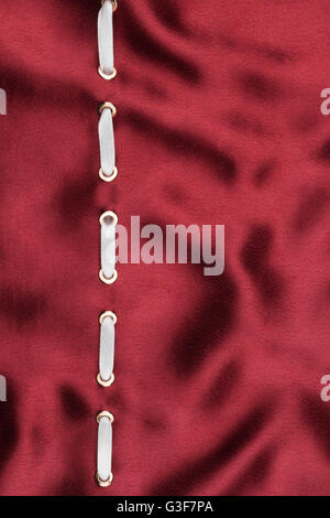 Fashionable beautiful background, white satin ribbon inserted in red satin fabric, with space for your creativity Stock Photo