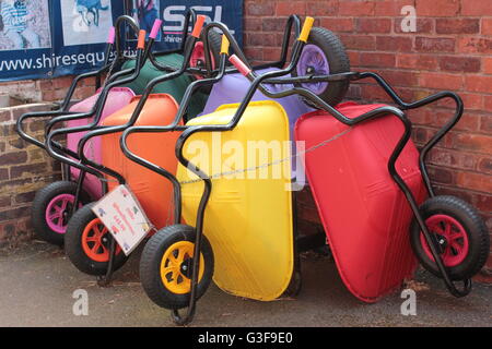 Multi-colored wheelbarrows Stock Photo