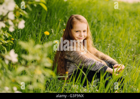 Portrait of little cute beautiful girl in garden Stock Photo