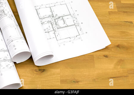 architectural background with floor plans and rolled technical drawings Stock Photo