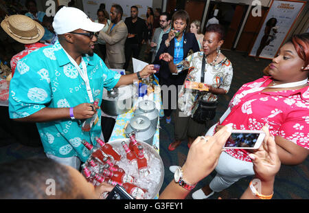 Miami, Florida, USA. 9th June, 2016. Guests tasste beverages at The Bahamas display for the Caribbean Festival during the 5-day Taste of the Caribbean Culinary Showcase presented by the Caribbean Hotel & Tourism Association at Hyatt Regency Miami on June 9, 2016 in Miami, USA. Credit:  SEAN DRAKES/Alamy Live News Stock Photo