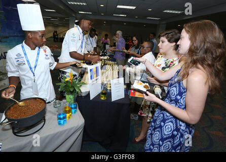 Miami, Florida, USA. 9th June, 2016. Guests sample traditional cou cou and pork stew by Team Barbados at the Caribbean Festival during the 5-day Taste of the Caribbean Culinary Showcase presented by the Caribbean Hotel and Tourism Association at Hyatt Regency Miami on June 9, 2016 in Miami, USA. Credit:  SEAN DRAKES/Alamy Live News Stock Photo