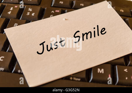 Just smile concept on black keyboard background Stock Photo