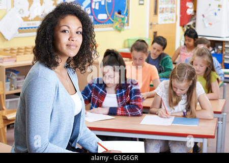 Portrait Of Teacher In Class With Pupils Stock Photo