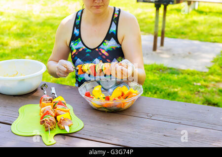 Meat and vegetable skewers on grill in nature Stock Photo