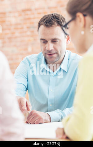 Business team of people in casual talking at meeting table Stock Photo