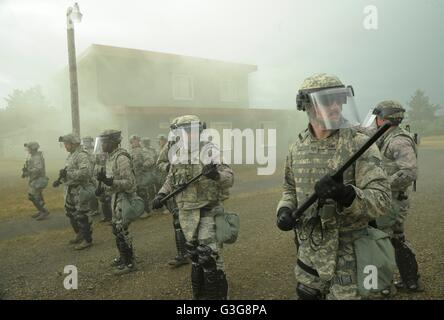 Oregon Air National Guard Security Force members train during riot control operations against simulated protestors at the Camp Rilea training village June 10, 2016 in Warrenton, Oregon. The training is part of exercise Cascadia Rising role playing scenario following a 9.0 magnitude earthquake. Stock Photo