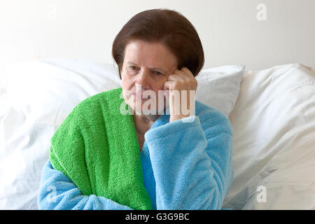 Pensive senior woman in bed. Stock Photo