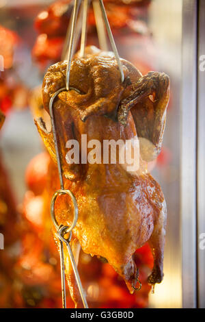 Scene in Chinatown, Honolulu, Oahu, Hawaii, Roast ducks hanging in shop window Stock Photo