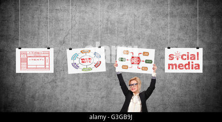 Businesswoman holding placard with drawing seo  scheme over head. Three poster hanging on a rope Stock Photo