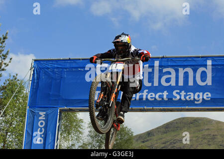 Aaron Gwin USA jumping through the Scotland Arch at the Downhill Mountain Bike World Cup at Fort William, Scotland on June 5th 2 Stock Photo