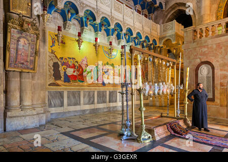 Stone of Anointing and mosaic icon on the wall at the entrance to Holy Sepulcher church in Jerusalem. Stock Photo