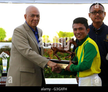 Philippines. 15th May, 2016. PHILRAMCO Commissioner Andrew Sanchez (left) awarded the trophy to Jockey J. A. Guce (right) after winning for 2016 PHILRAMCO “1st Leg Triple CROWN Stakes Race” during the 14th KDJM Anniversary Trophy Race Santa Ana Park in Naic Cavite Province. © Gregorio B. Dantes Jr./Pacific Press/Alamy Live News Stock Photo