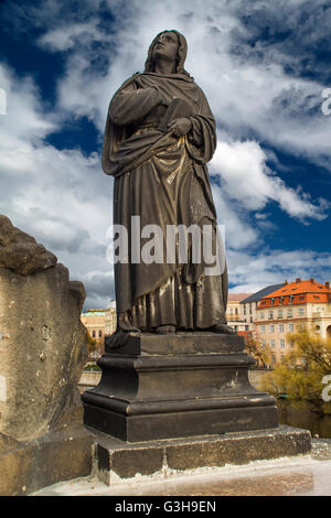 Statue of Jesus Christ on the Cross on Charles Bridge in Prague, Czech Republic Stock Photo