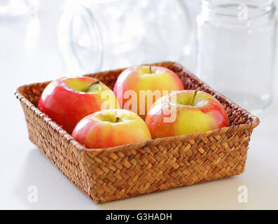 Colorful shiny apples in a basket for preserve Stock Photo