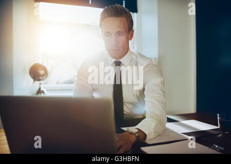 Young business man working on laptop at his office Stock Photo