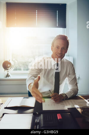 Business man holding out hand to close deal and welcome you, business partners concept Stock Photo