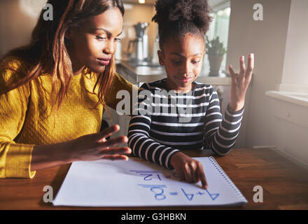 Mother learning child to calculate, black mother and daughter Stock Photo