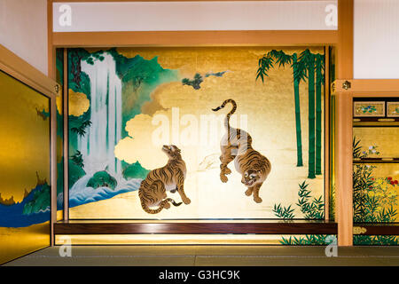 Japan, Nagoya castle. Reconstructed Hommaru Palace interior. Room, part of the Omote Shoin, main hall, with wall painting of two tigers and waterfall. Stock Photo