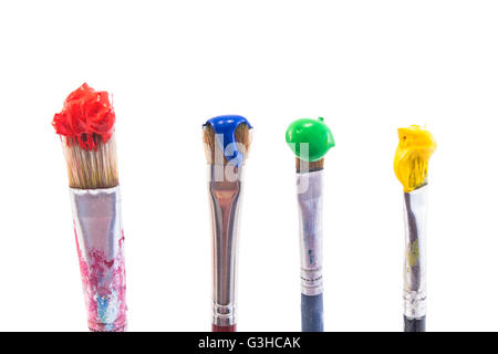 Brushes with Paint Isolated on White. Stock Photo