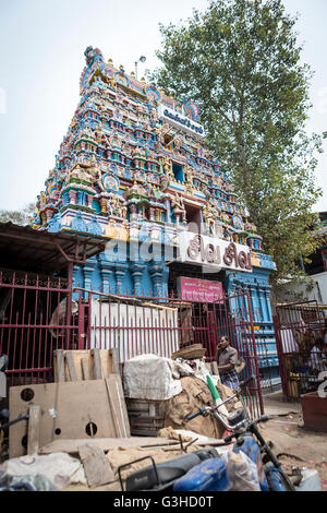 Indian Temple with a pile of rubbish outside the boundary fence Stock Photo