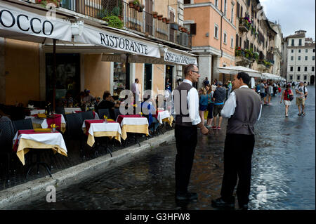 Waiters on a rainy day in Rome , Italy Stock Photo