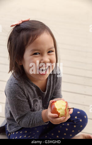 happy girl hands holding a red bitten apple,health concept, toning Stock Photo