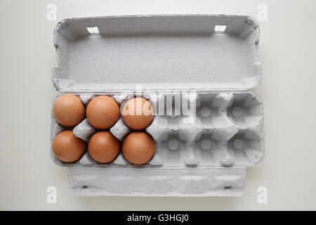 Eggs in packaging, missing eggs, half empty half full Stock Photo