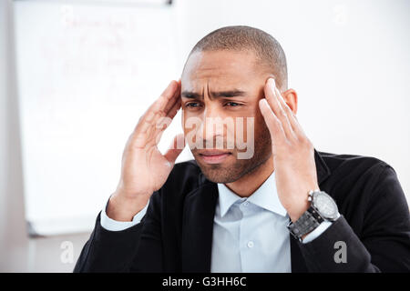 Close-up portrait if a pensive stressed out businessman in the office Stock Photo