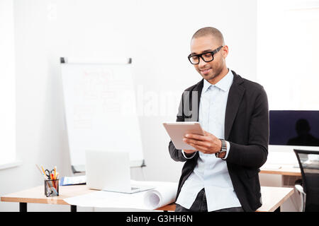 Happy young businessman using pc digital tablet in office Stock Photo
