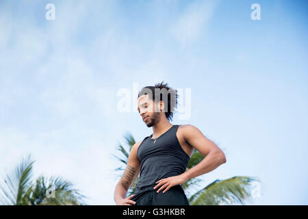 Man daydreaming, palm trees in background Stock Photo