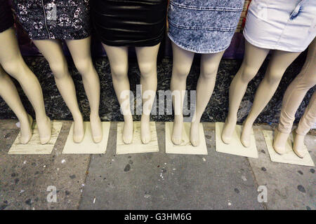 Detail of six female dummies on sidewalk wearing mini skirts Stock Photo