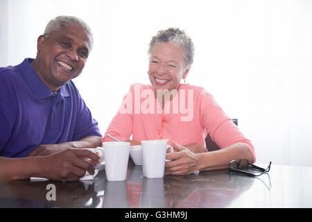 Portrait of senior couple having breakfast, smiling Stock Photo