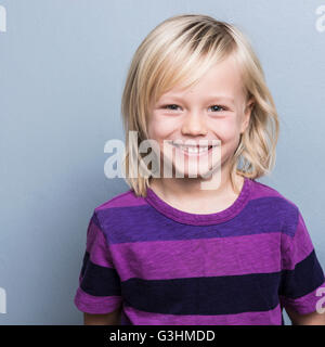 Portrait of blonde haired boy looking at camera smiling Stock Photo