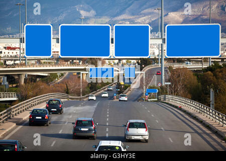 Cars on highway with blank directional road signs Stock Photo - Alamy