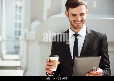 Positive content man using tablet Stock Photo