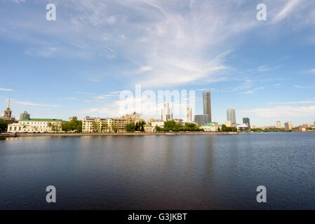 City Pond in Yekaterinburg Russia during the daytime with water reflections of the vast business skyscrapers in daylight. Stock Photo